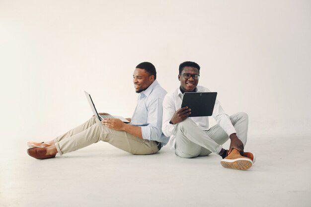 two young black men working together use laptop 1157 295553695383955609890417